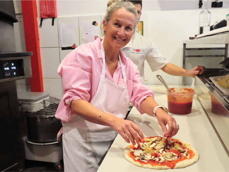 Woman smiling at a pizza making class
